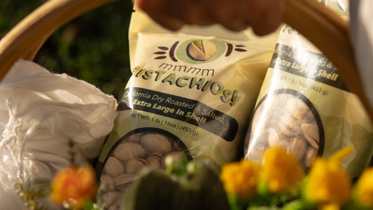 mmmm Pistachios! on a wooden basket full of flowers.