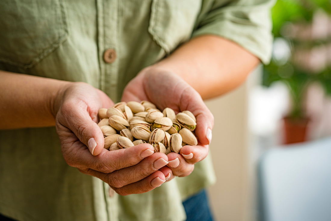 Person holding in shell pistachios